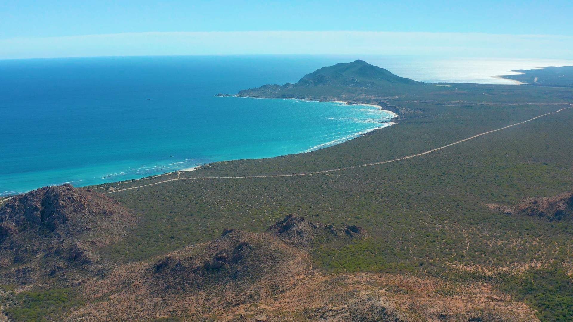 Remote route south of Cabo Pulmo Bay with mountains, desert, and the Sea of Cortez