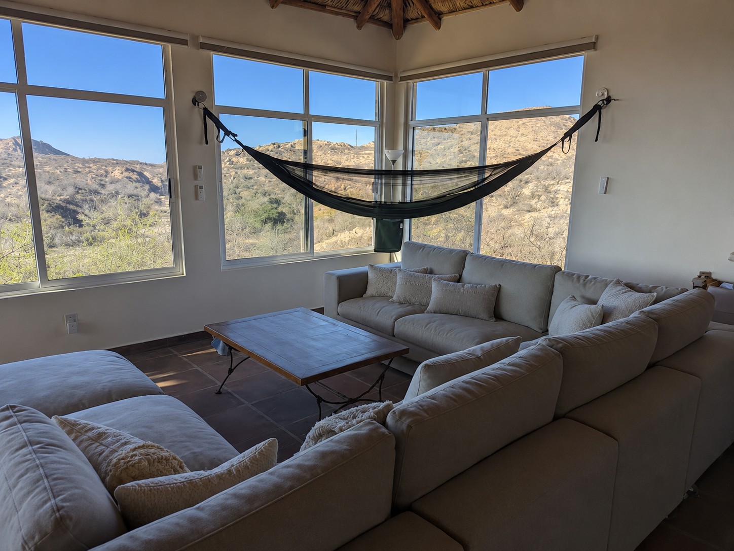 Hammock and lounge area inside the main living room at Cabo House