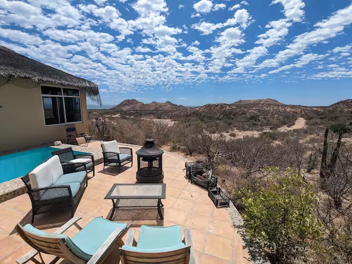 Outdoor patio at Cabo House overlooking the desert and distant Sea of Cortez